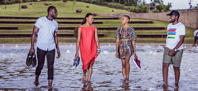 Several people stand in a fountain, which can be enjoyed when you book your hotel or other accommodation in Pretoria with Flight Centre. 