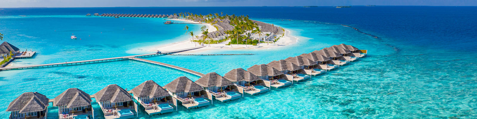 A view of oversea bungalows in the Maldives, which can be experienced with a holiday package from Flight Centre.