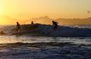 Surfers riding the waves